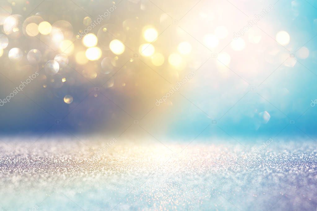 abstract glitter lights background. golden and light blue. de-focused