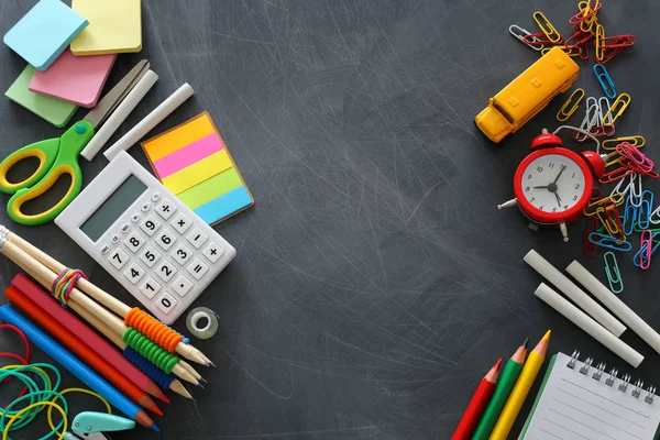 Education and back to school concept. stationery and bus over classroom blackboard. top view — Stock Photo, Image