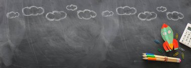 Eğitim. Okul konseptine geri dönelim. kağıttan kesilmiş ve kara tahta arka plan üzerine boyanmış roket. üst görünüm, düz yatıyordu. Afiş