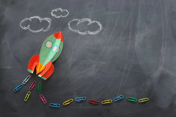 Education. Back to school concept. rocket cut from paper and painted over blackboard background. top view, flat lay — Stock Photo, Image