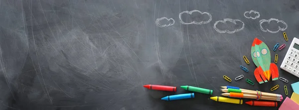 Education. Back to school concept. rocket cut from paper and painted over blackboard background. top view, flat lay. banner — Stock Photo, Image