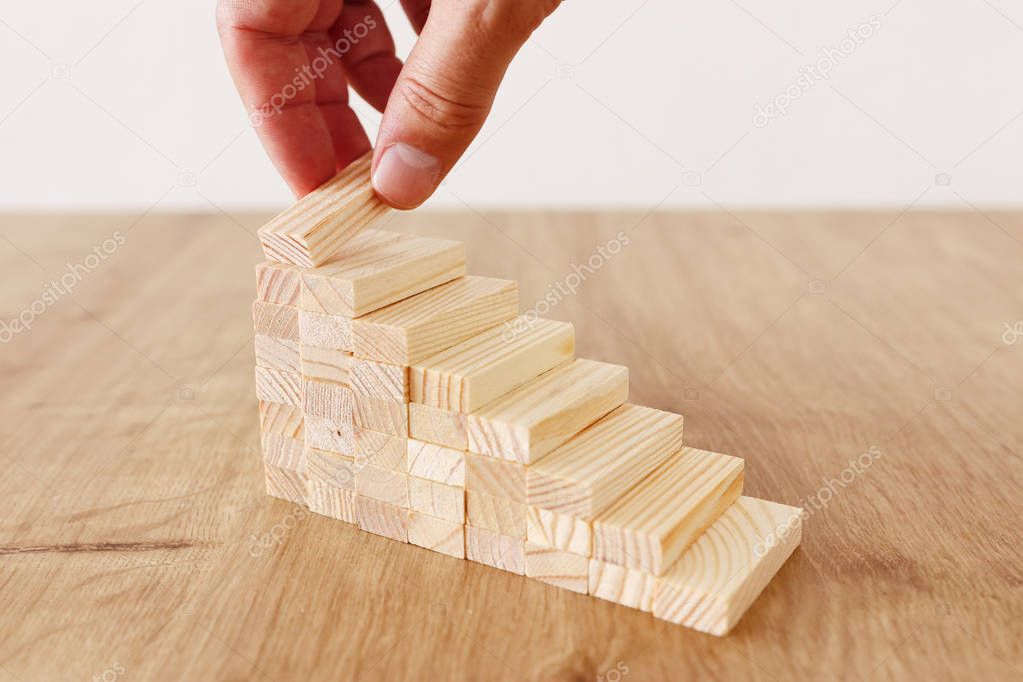 Business image of arranging wood blocks stacking as step stairs. Success and development concept