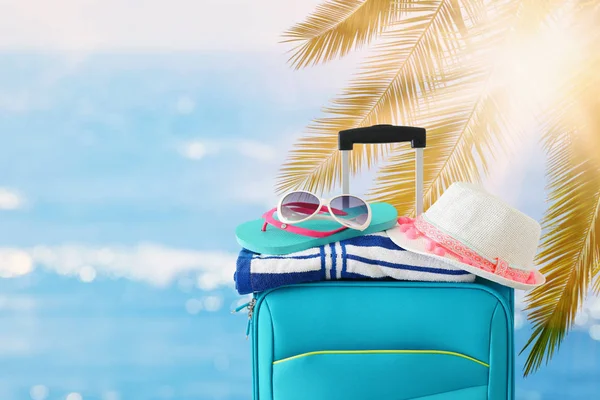 Holidays. travel concept. blue suitcase with female hat, flip fl — Stock Photo, Image