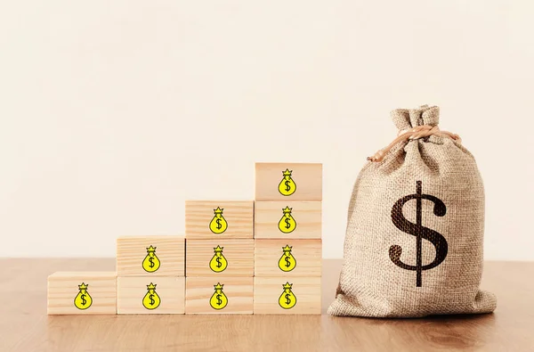 business image of a sack with money over wooden desk