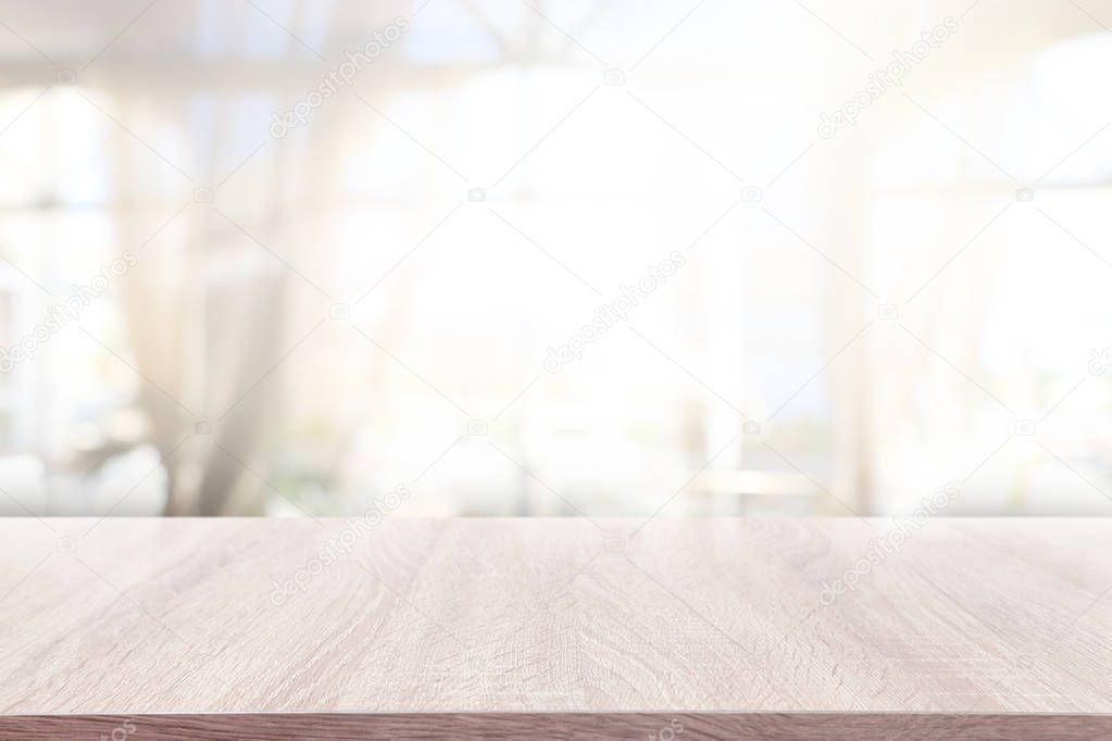 background of wooden table in front of abstract blurred window light