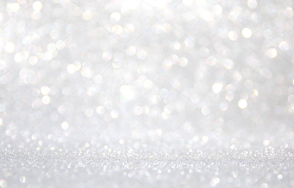 background of abstract glitter lights. silver and white. de-focused