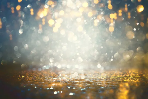 Background of abstract glitter lights. gold and black. de-focused. — Stock Photo, Image