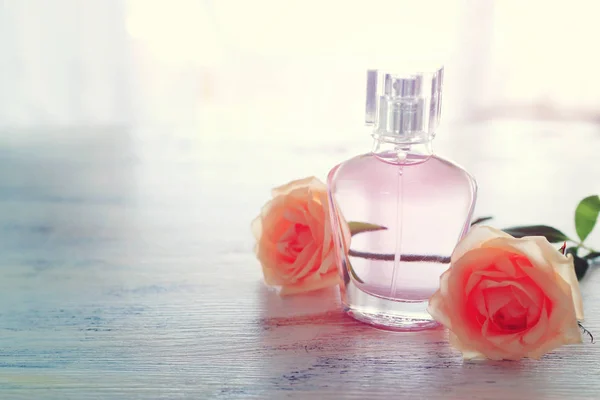 Beauty / fashion Immagine di elegante bottiglia di profumo e delicate rose su sfondo pastello. immagine filtrata vintage — Foto Stock