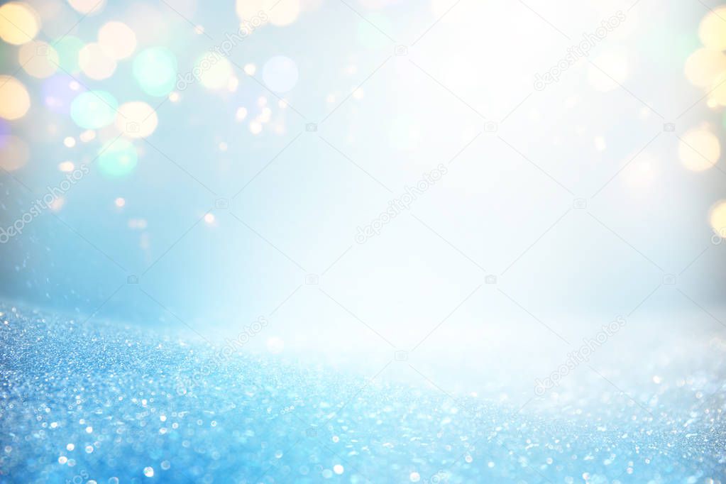 blackground of abstract glitter lights. blue, gold and silver. de focused