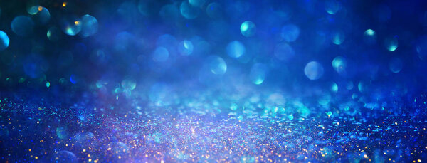 blackground of abstract glitter lights. blue, gold and black. de