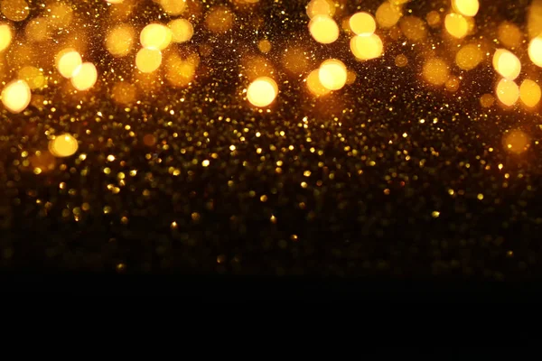 Fondo de luces de brillo abstractas. oro y negro. desenfocado — Foto de Stock