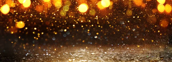 Hintergrund abstrakter Glitzerlichter. Gold und Schwarz. Entfokussiert. Banner — Stockfoto