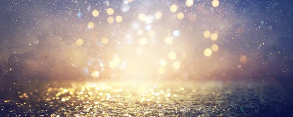 Hintergrund abstrakter Glitzerlichter. blau, gold und schwarz. Defokussiert. Banner — Stockfoto