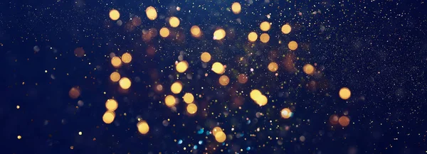 Achtergrond van abstracte glitter lichten. blauw, goud en zwart. de focus. Banner — Stockfoto