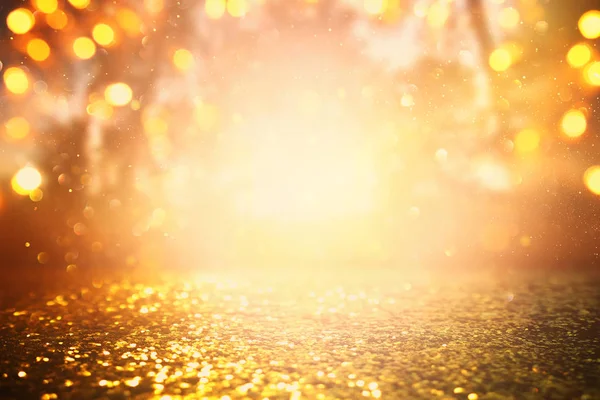 Abstract background of light burst among trees and glitter golden bokeh lights — Stock Photo, Image