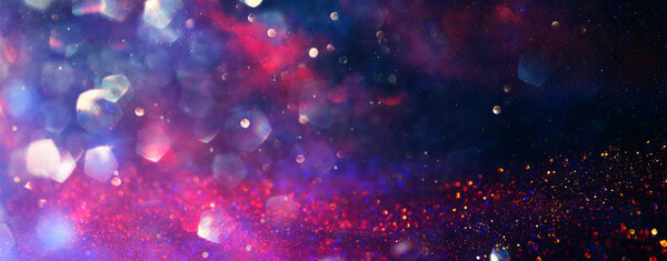 Background of abstract red, gold and purple glitter lights. defocused. banner