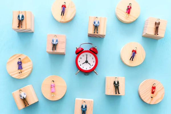 Business image of time management concept. Group of people and alarm clock, deadline and teamwork metaphor