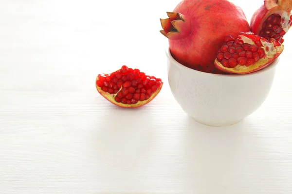 Rosh hashanah (jewesh holiday) concept -pomegranate traditional holiday symbol over white background — Stock Photo, Image