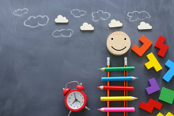 Education concept of Ladder made from pencils next to clouds over blackboard — Stock Photo, Image