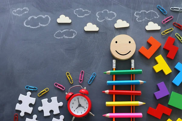 Education concept of Ladder made from pencils next to clouds over blackboard — Stock Photo, Image