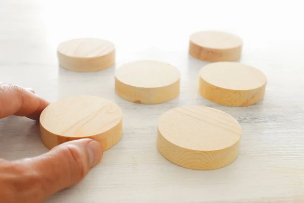 Business concept of man hand arranging wooden round blocks. mock up or template — Stock Photo, Image