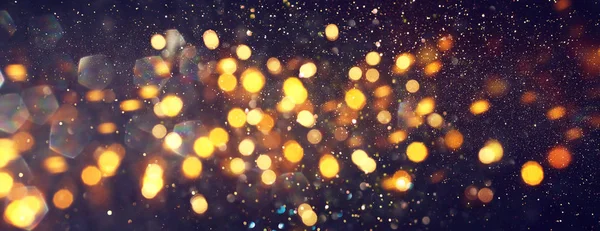 Background of abstract glitter lights. gold and black. de focused. banner — Stock Photo, Image