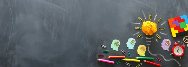 Education concept image. Creative idea and innovation. Crumpled paper as light bulb metaphor over blackboard — Stock Photo, Image