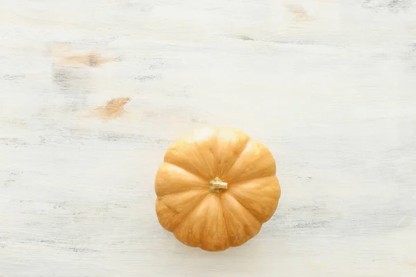 holidays Halloween image. pumpkin over wooden white table. top view, flat lay