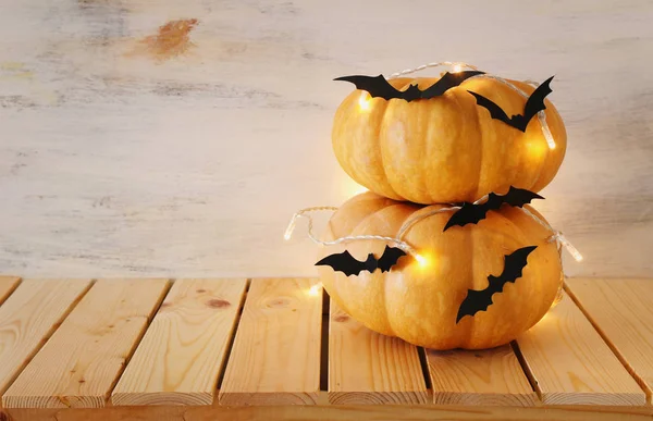 holidays Halloween image. pumpkins and bats over wooden white table