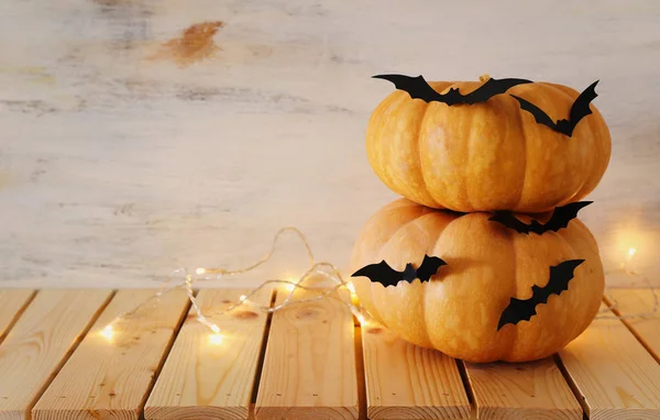 holidays Halloween image. pumpkins and bats over wooden white table