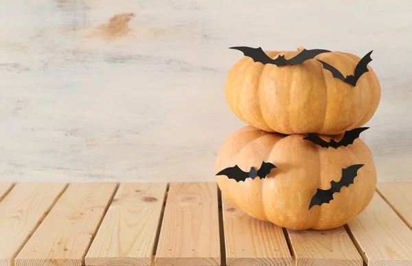 holidays Halloween image. pumpkins and bats over wooden white table
