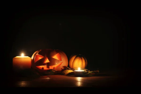 Vakantie foto van Halloween. Pompoenen over houten tafel donkere achtergrond — Stockfoto