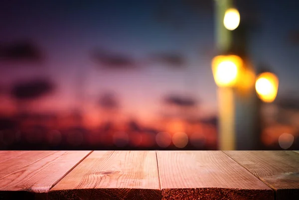 Fondo de la mesa de madera frente a las luces abstractas borrosas del restaurante —  Fotos de Stock