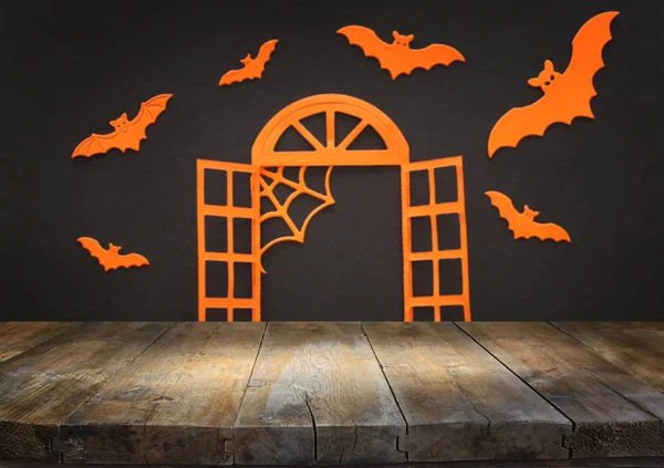 Holidays concept of Halloween. Empty rustic table in front of open window and bats over black background. Ready for product display montage — Stock Photo, Image