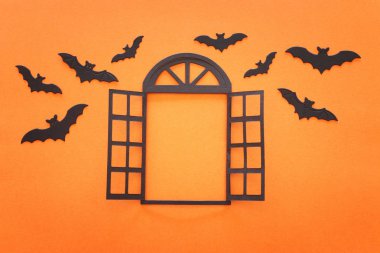holidays concept of Halloween . open window and bats over orange background. Top view, flat lay