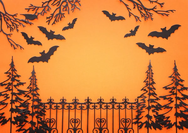 holidays Halloween concept. haunted alley with trees and bats over orange background. Top view, flat lay
