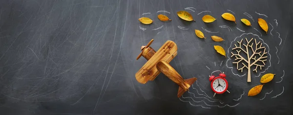 Education concept, banner of vintage airplane on a chalkboard with fall leaves — Stock Photo, Image