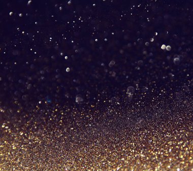background of abstract glitter lights. gold and black. de focused clipart