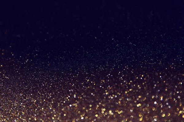 Sfondo di luci glitter astratte. oro e nero. de focalizzata — Foto Stock