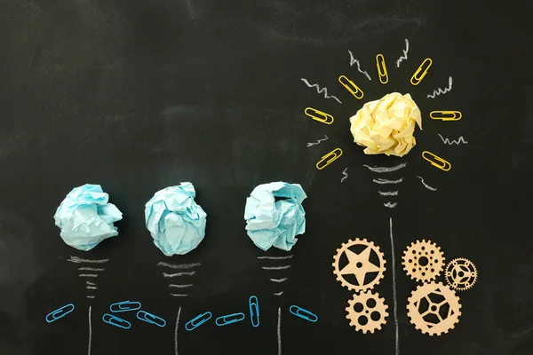 Education concept image. Creative idea and innovation. Crumpled paper as light bulb metaphor over blackboard — Stock Photo, Image