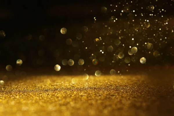 Hintergrund abstrakter Glitzerlichter. Gold und Schwarz. de fokussiert — Stockfoto