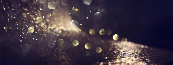 Background of abstract glitter lights. gold and black. de focused. banner — Stock Photo, Image