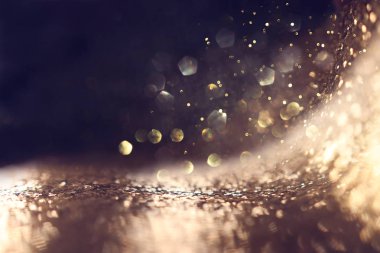 Soyut parıltılı ışıkların arkaplanı. Altın ve siyah. Odaklanma