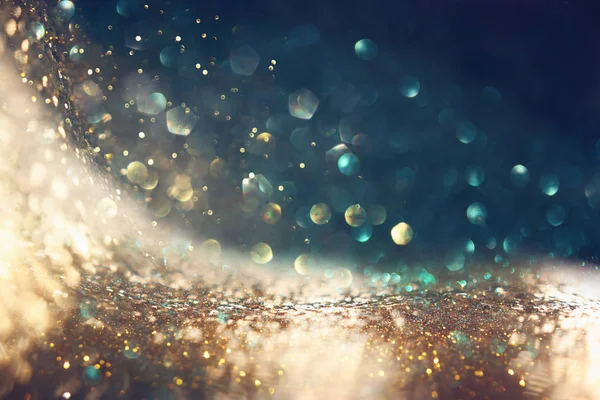 Hintergrund abstrakter Glitzerlichter. Gold und Schwarz. de fokussiert — Stockfoto