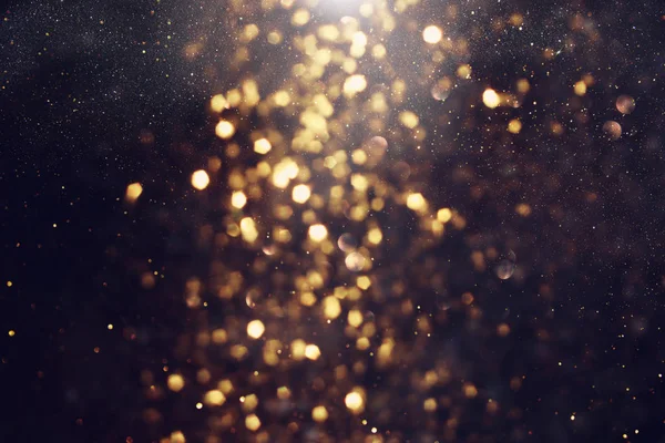 Hintergrund abstrakter Glitzerlichter. Gold und Schwarz. de fokussiert — Stockfoto