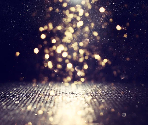 Csillogó fények a háttérben. arany és fekete. de fókuszált — Stock Fotó