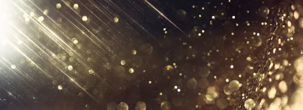 Background of abstract glitter lights. gold and black. de focused. banner — Stock Photo, Image