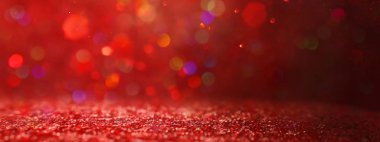 Soyut kırmızı, altın ve siyah parıltılı ışıkların arkaplanı. Dikkati dağılmış. Pankart