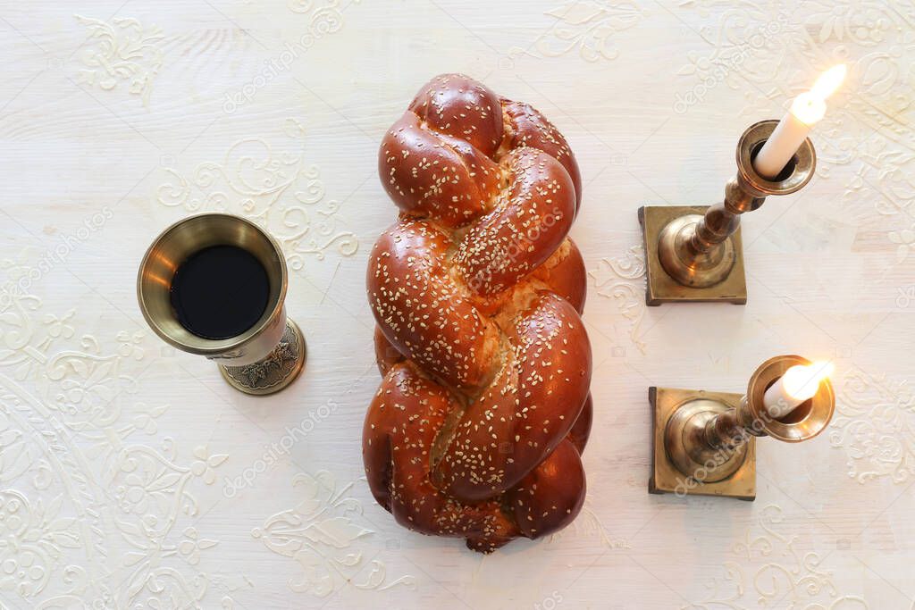shabbat image. challah bread, shabbat wine and candles. Top view