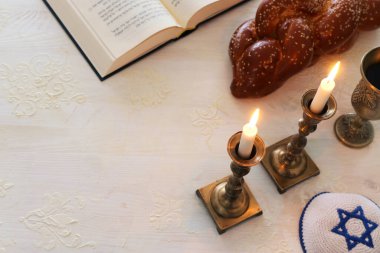 Shabbat görüntüsü. Challah ekmeği, Şabat şarabı ve mumlar. Üst görünüm